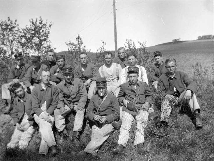 a black and white po of men posing for a picture