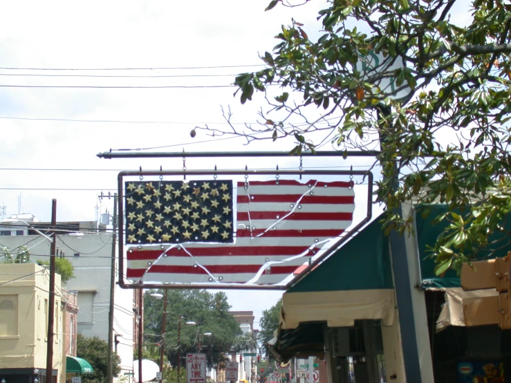 an american flag sign is shown on a city street