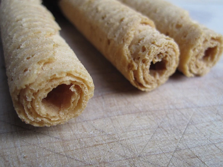 a close up view of two uncooked bread roll on a  board