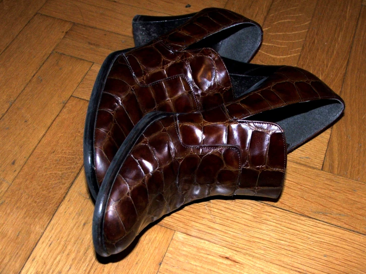 pair of slippers sitting on the ground on wooden floor