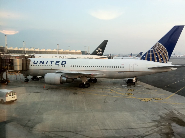 two united airplanes at the gate at an airport