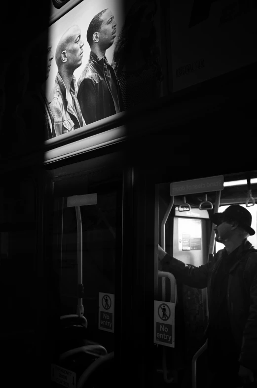 a man looking in the window of a subway car