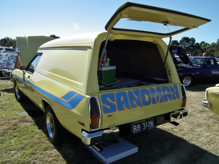 a pick up truck with its open hood in the back