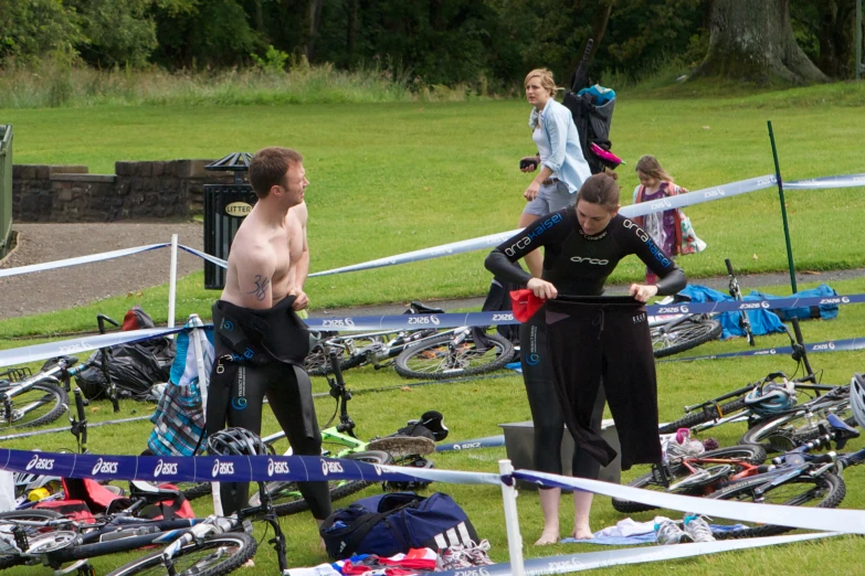 people standing near bikes outside in the grass