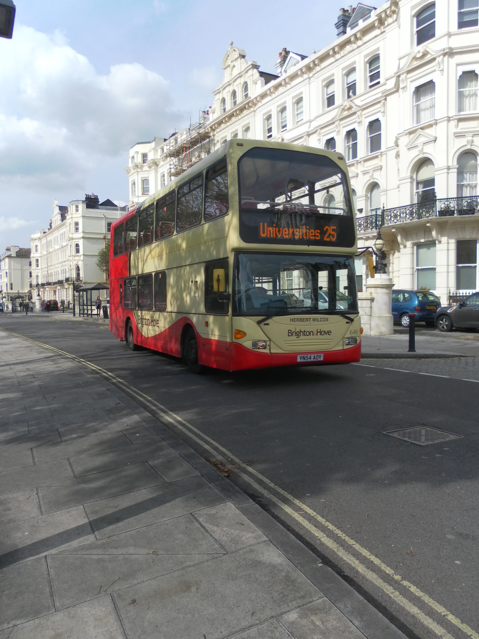 a double decker bus on a street next to buildings