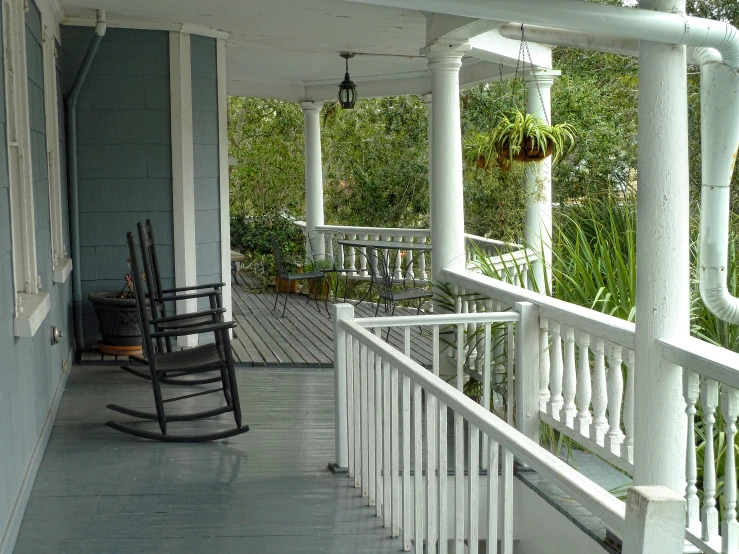 the porch is covered with black and white furniture