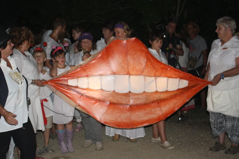people wearing costumes pose for an image with tooth shaped balloons