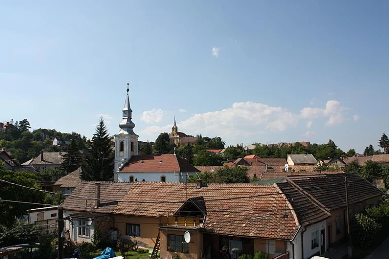 a church steeple surrounded by buildings and trees