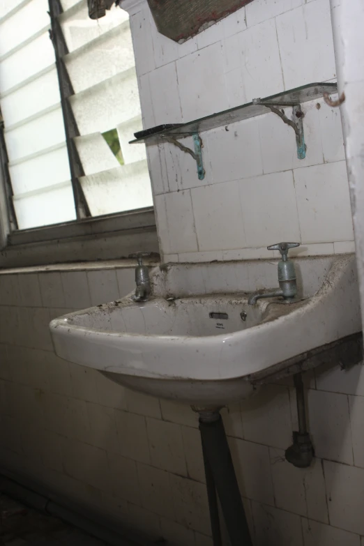 a white sink that is under a mirror