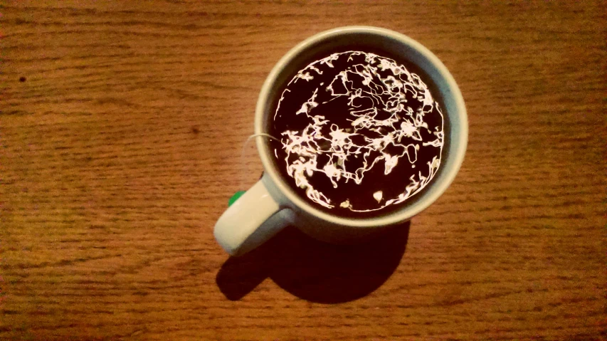 the coffee has chocolate sauce on it in a white cup