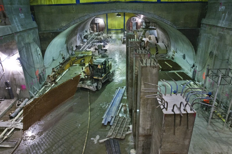 a tunnel under construction with tools and trucks on it