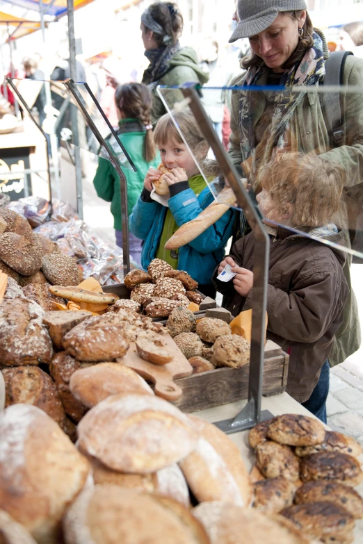 a woman and child looking at some donuts on display