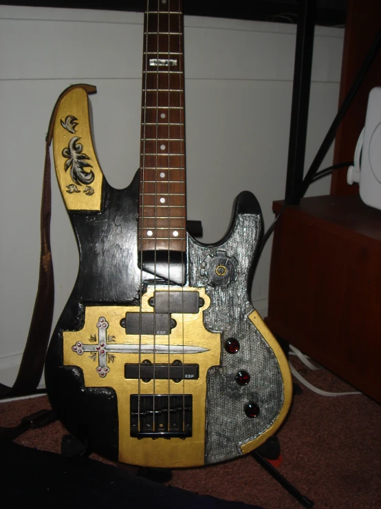 a toy guitar sitting next to a wall