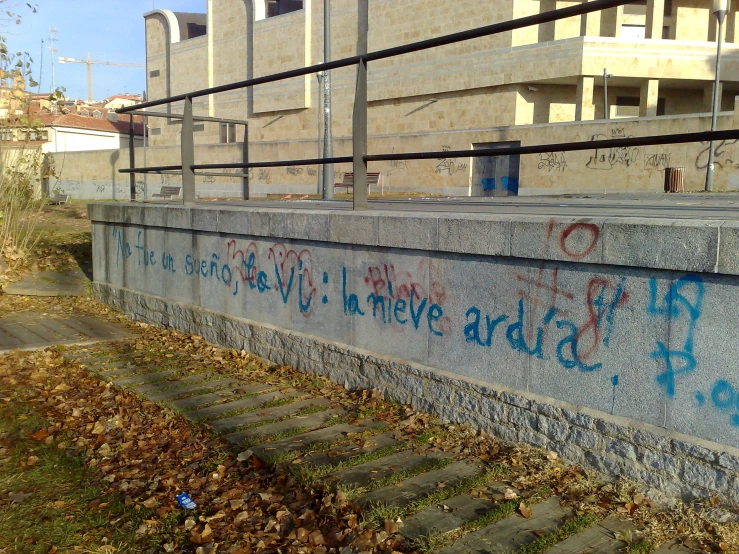 an old concrete wall with graffiti on it