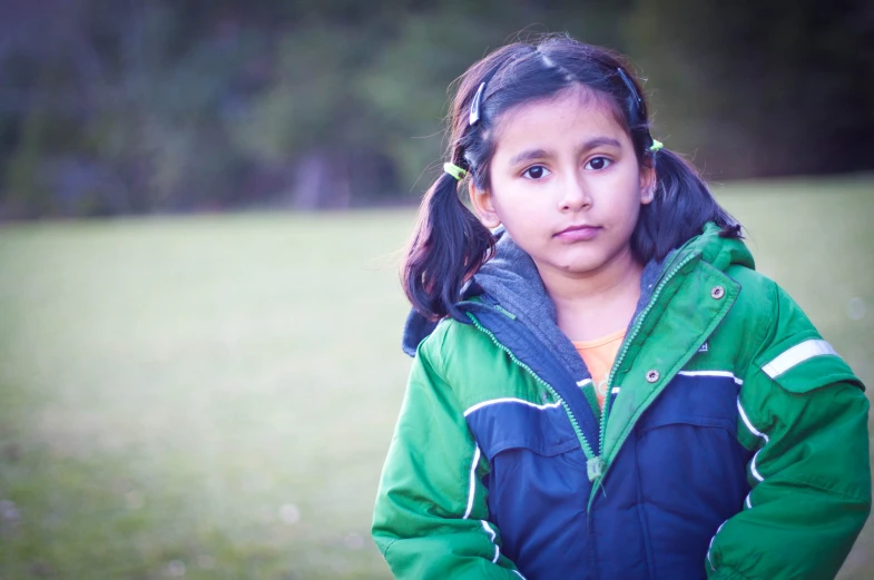 a  standing in a field looking at the camera