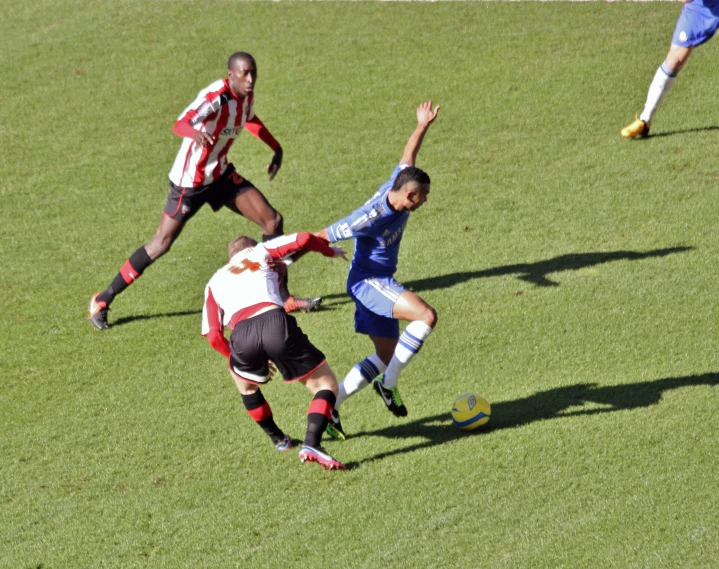 a soccer match with three opposing teams on the field