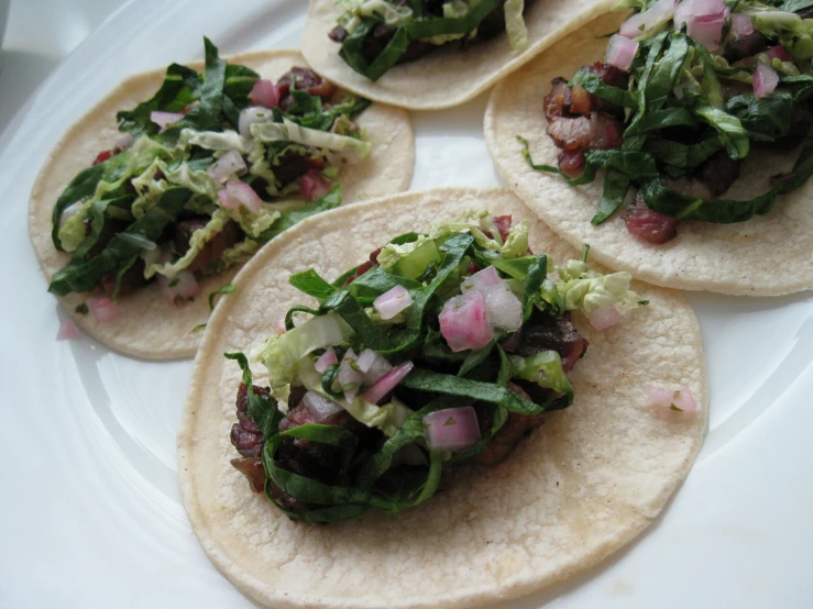 a close up of a plate of food with tortillas