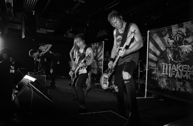 a group of people on stage playing guitar