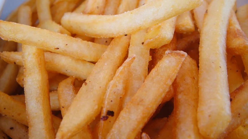 a plate of french fries are on the table