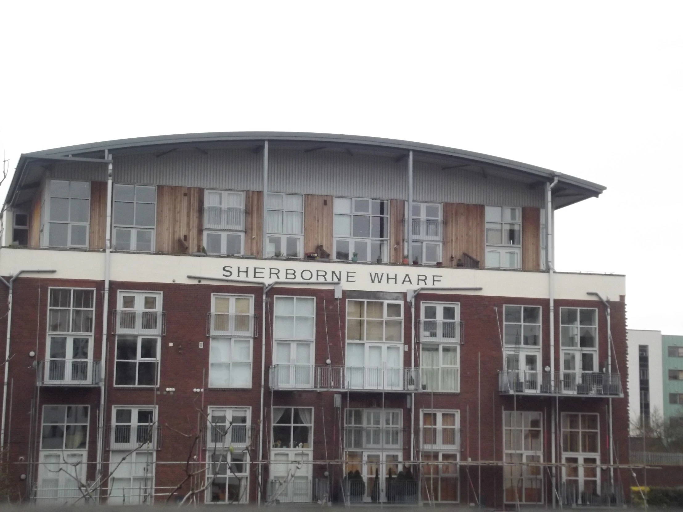 large building with some boarded doors next to street