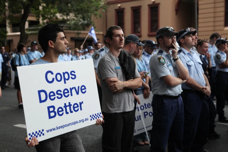 a group of cops standing together with signs