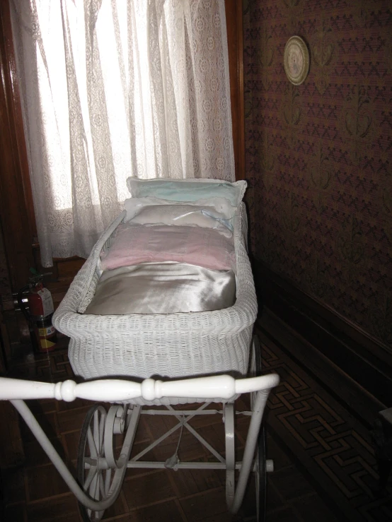 there is a small baby carriage that is in the room