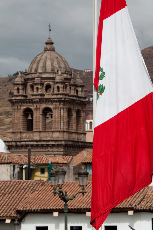 a flag flying in front of an old church