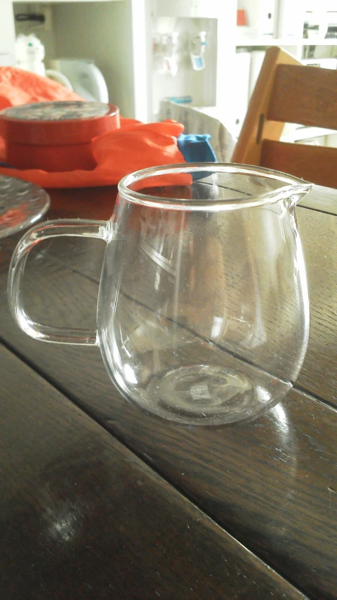 a large clear glass mug sitting on a wooden table