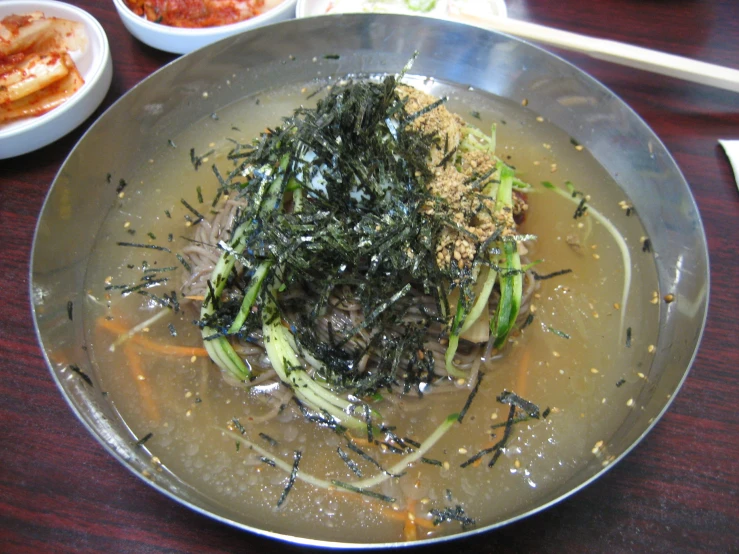 an oriental bowl with a brown substance on the table