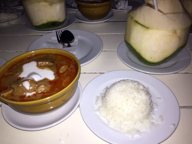 several plates with different foods in them, including watermelon and rice