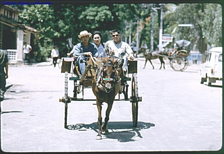 two people and a horse that is pulling a cart