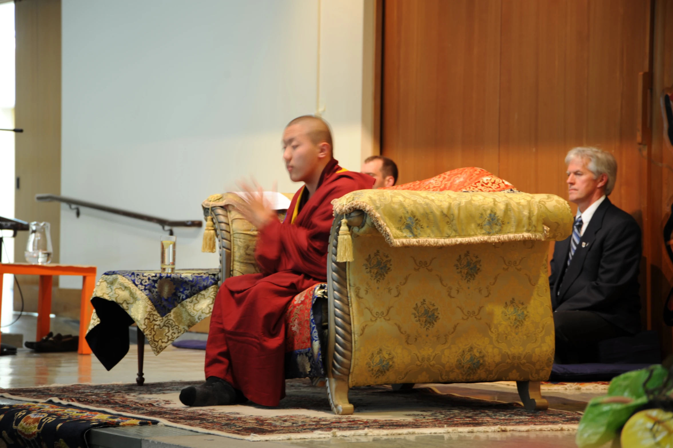 a buddhist monk is sitting on the floor and praying