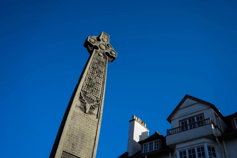 a clock tower with the face of jesus on it and a building in the background