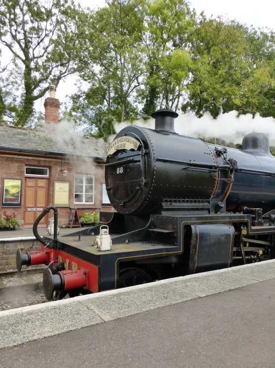 a small steam locomotive parked at a station