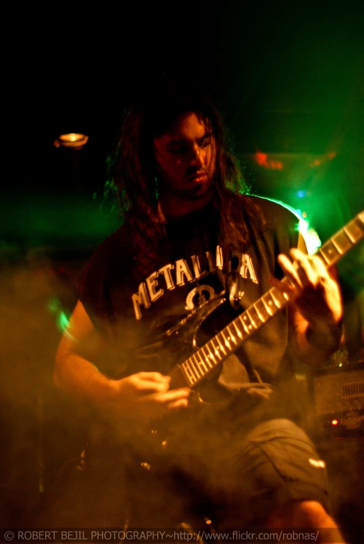 a man is playing the guitar on stage