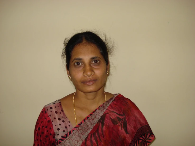 an indian woman wearing a red and pink sari