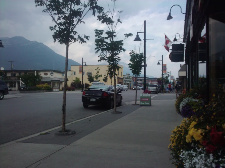 a street view looking at a car on the side of the road