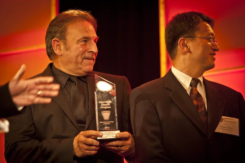 two men in business suits talk to one another