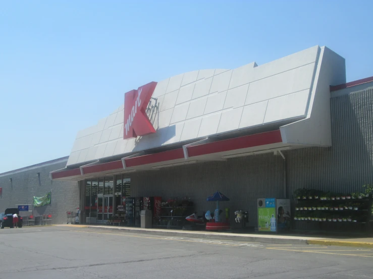 a big building with a red and white awning