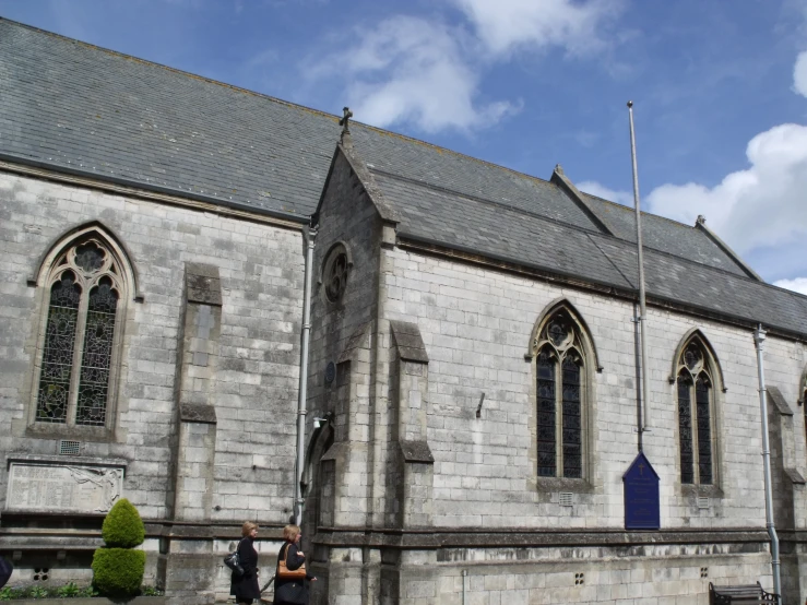 this old church has a large window and arches