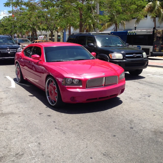 a bright pink car in a parking lot