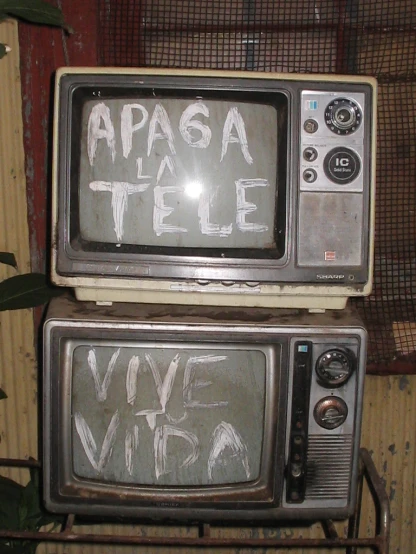 two old televisions with words written on them