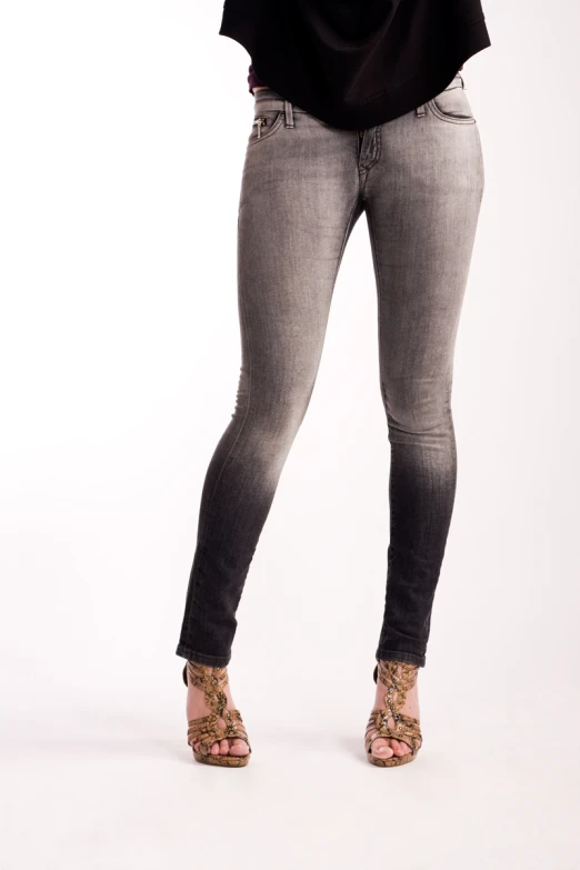 woman posing for pograph in a pair of grey jeans