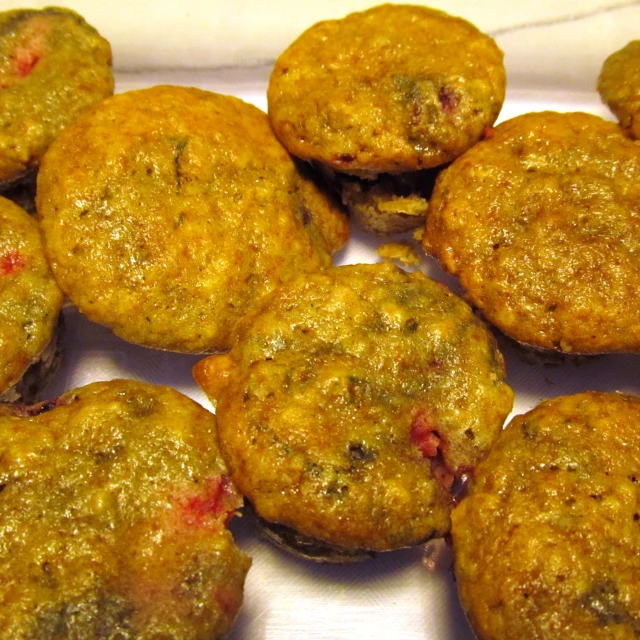 several muffins are shown with fruit on top