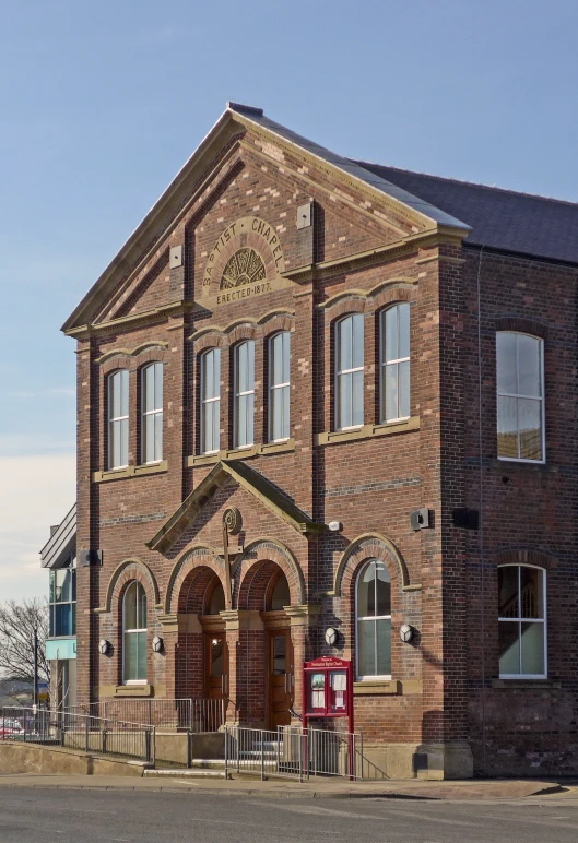 an old brick church with a street sign in front