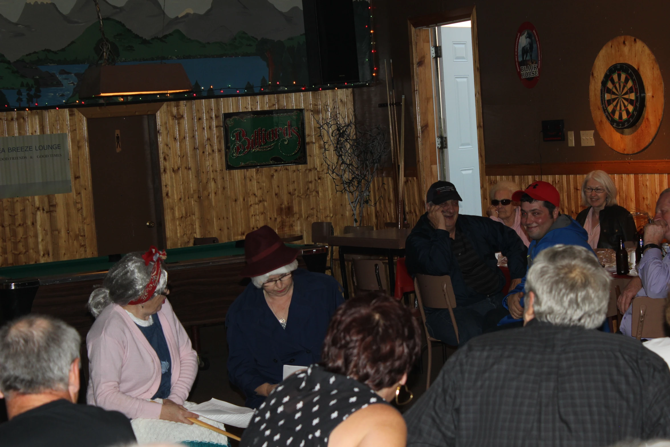 several elderly people sitting at a table together