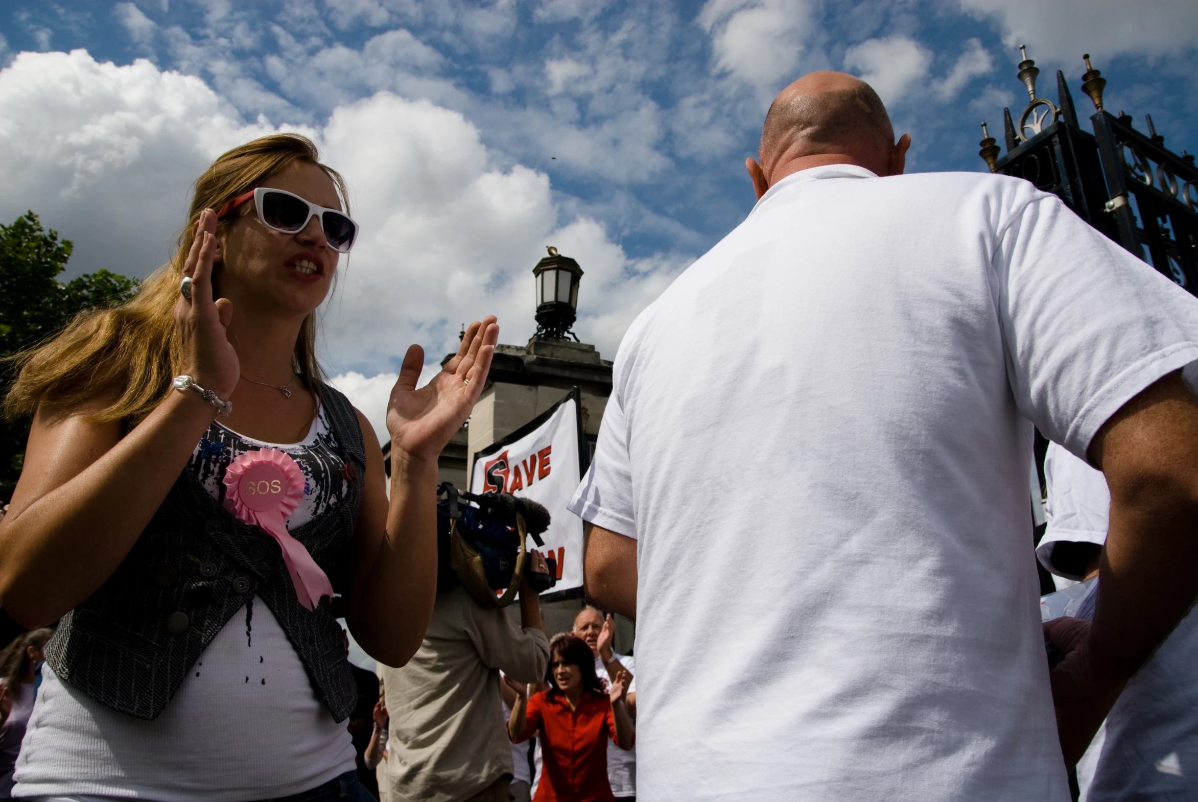 two people are standing together and a man is clapping