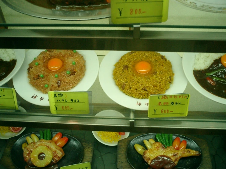 a glass case is displaying plates and food