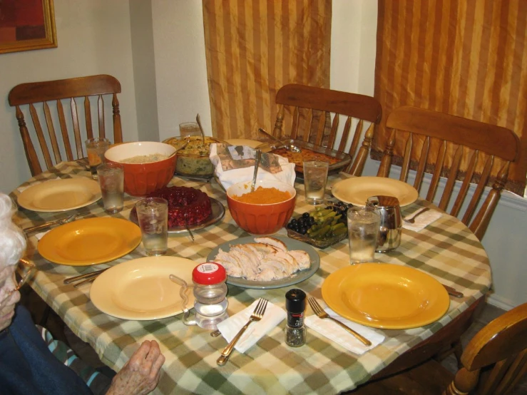 two older people sit at the dinner table