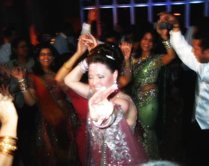 a woman in a red dress on the dance floor at a party